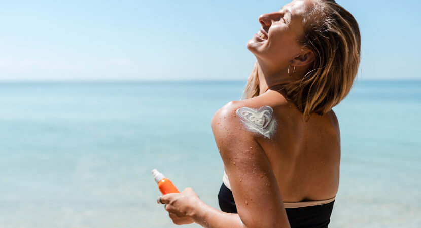 bride applying sunscreen before wedding for glowing skin